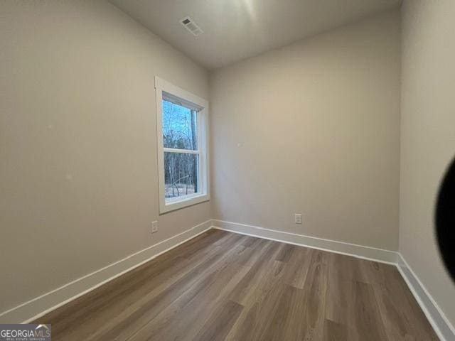 empty room featuring hardwood / wood-style flooring