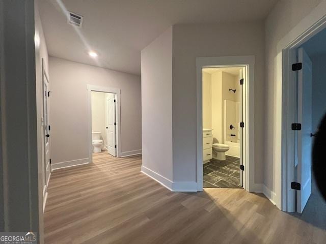 corridor with wood-type flooring