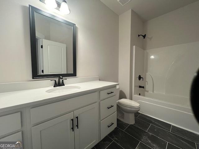 full bathroom featuring bathing tub / shower combination, vanity, and toilet