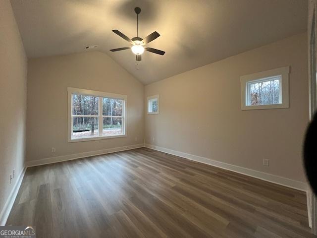 spare room featuring lofted ceiling, ceiling fan, and dark hardwood / wood-style floors