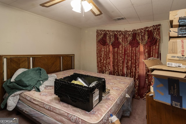 bedroom with carpet, ceiling fan, and crown molding