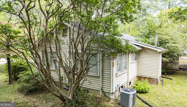 view of side of home featuring a yard