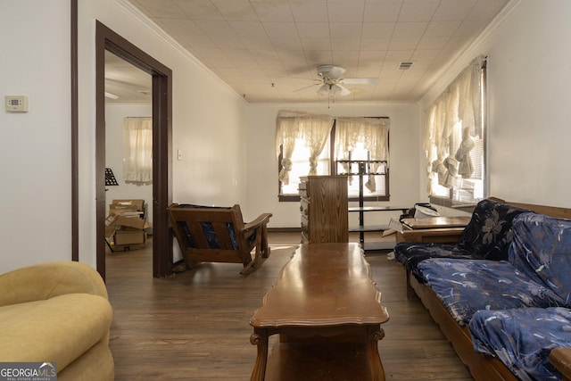 living room featuring crown molding, ceiling fan, and dark wood-type flooring