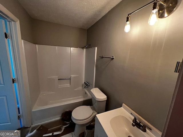 bathroom featuring vanity, toilet, tub / shower combination, and a textured ceiling