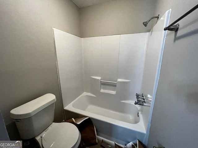 bathroom featuring toilet and  shower combination