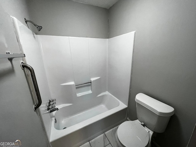 full bathroom featuring marble finish floor and toilet