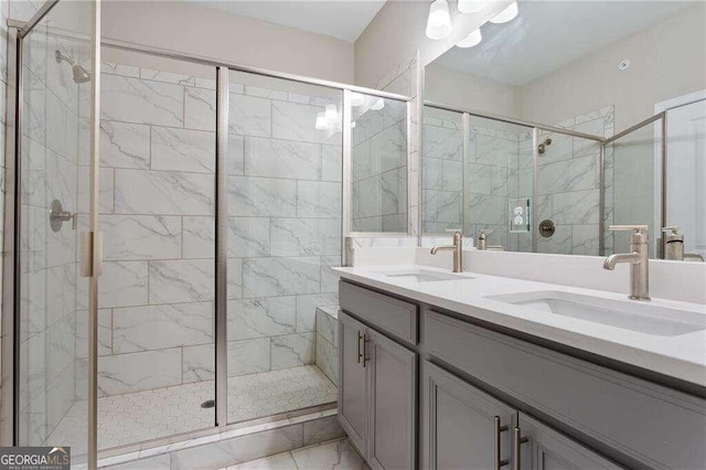 bathroom featuring a shower with door and vanity