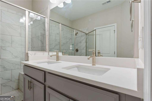 bathroom featuring a shower with shower door and vanity