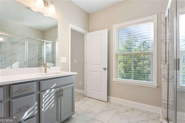 bathroom with vanity and a shower with shower door