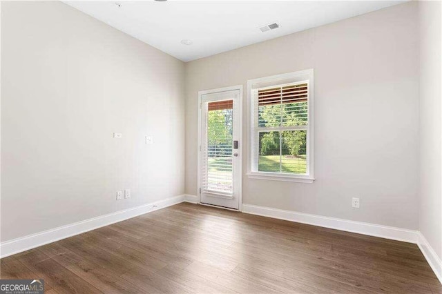 unfurnished room featuring dark hardwood / wood-style flooring