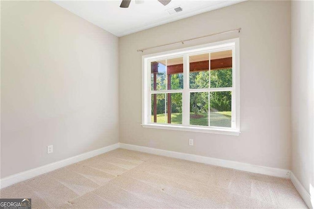 spare room featuring ceiling fan and light colored carpet