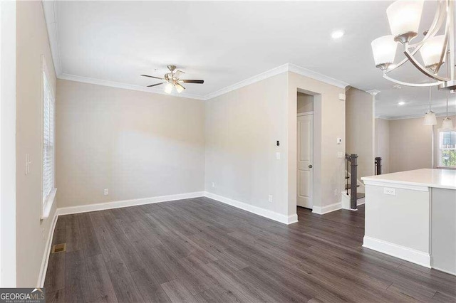 unfurnished room featuring crown molding, dark hardwood / wood-style floors, and ceiling fan with notable chandelier