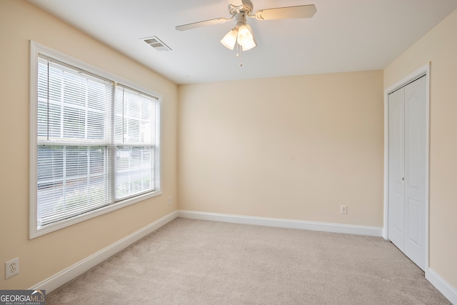 carpeted empty room with ceiling fan