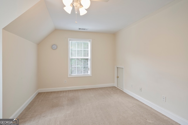 bonus room with vaulted ceiling, ceiling fan, and light colored carpet