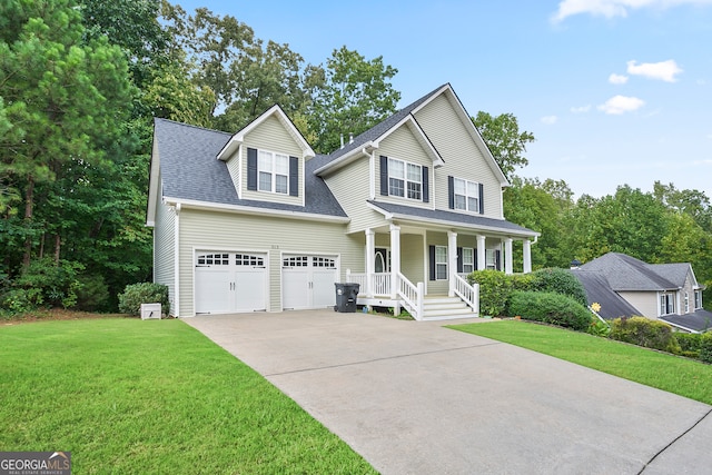 view of front of property featuring a garage, a front yard, and covered porch