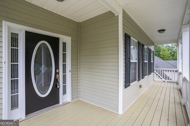 view of exterior entry with covered porch