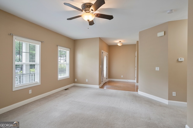 carpeted empty room featuring ceiling fan