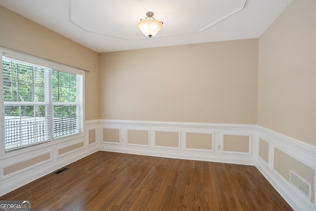 unfurnished room featuring dark wood-type flooring