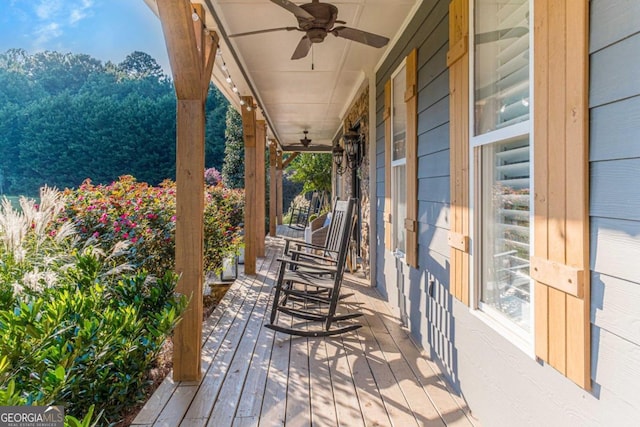 wooden terrace featuring ceiling fan and covered porch