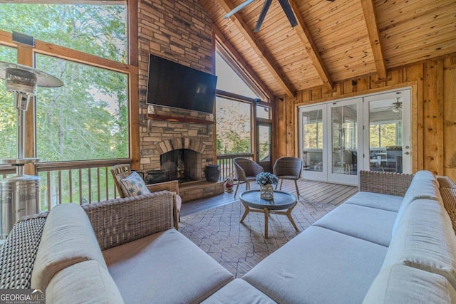 living room with ceiling fan, hardwood / wood-style flooring, a fireplace, and wooden ceiling