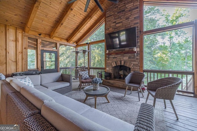 living room featuring high vaulted ceiling, ceiling fan, a wealth of natural light, and a fireplace