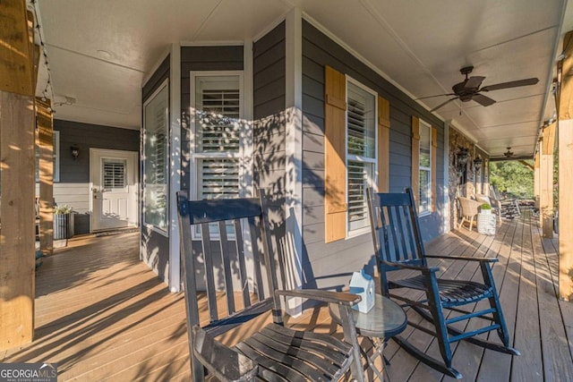 wooden deck with a porch and ceiling fan