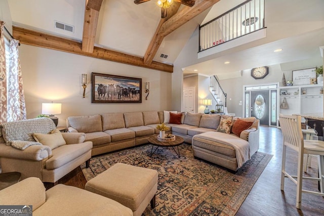 living room with high vaulted ceiling, hardwood / wood-style flooring, beam ceiling, and ceiling fan