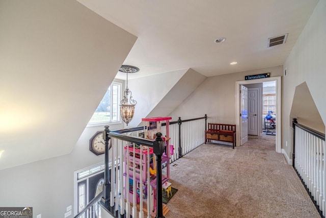 additional living space featuring carpet, an inviting chandelier, and vaulted ceiling