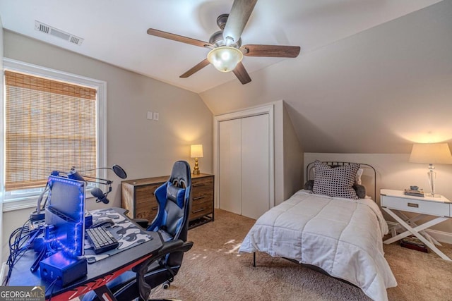 bedroom featuring lofted ceiling, ceiling fan, carpet floors, and multiple windows