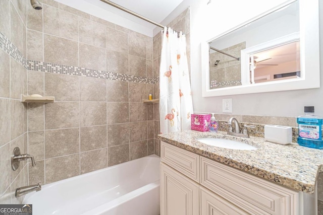 bathroom with vanity, shower / bath combination with curtain, and ceiling fan