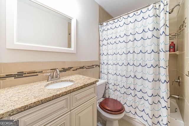 full bathroom featuring toilet, vanity, backsplash, tile walls, and shower / bath combination with curtain