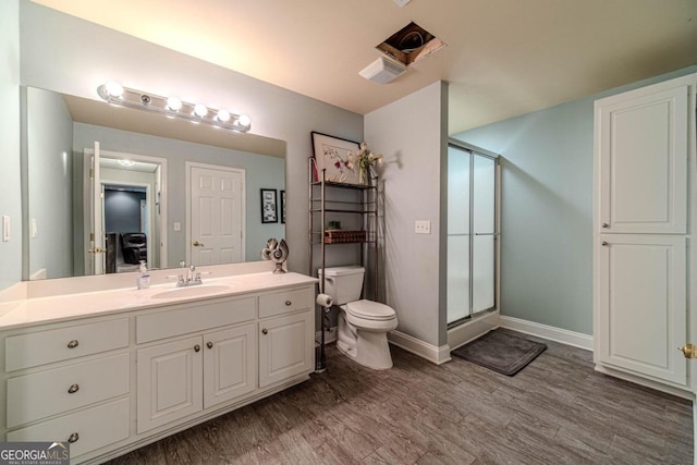 bathroom with vanity, toilet, wood-type flooring, and walk in shower