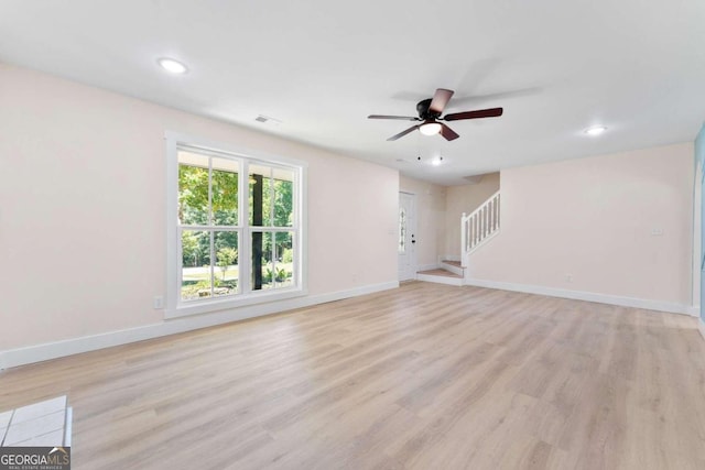 empty room with light hardwood / wood-style flooring and ceiling fan