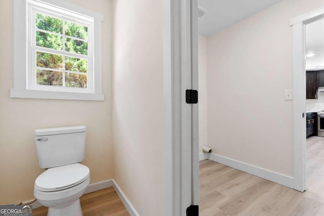 bathroom featuring toilet and hardwood / wood-style flooring