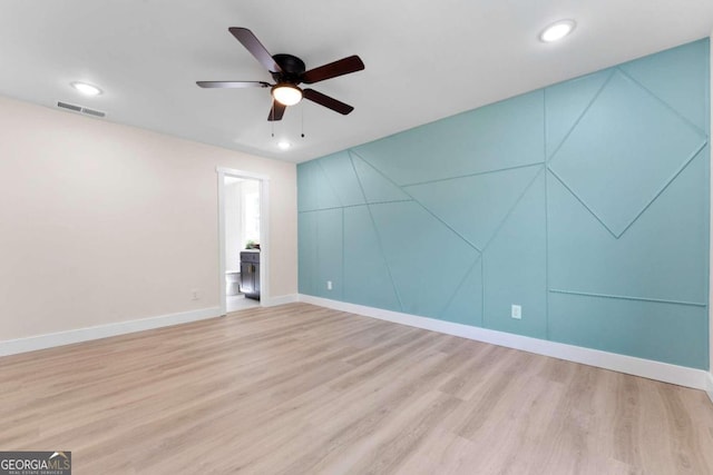 unfurnished room featuring hardwood / wood-style flooring and ceiling fan