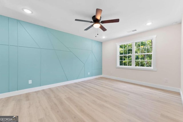 unfurnished room featuring ceiling fan and light hardwood / wood-style flooring