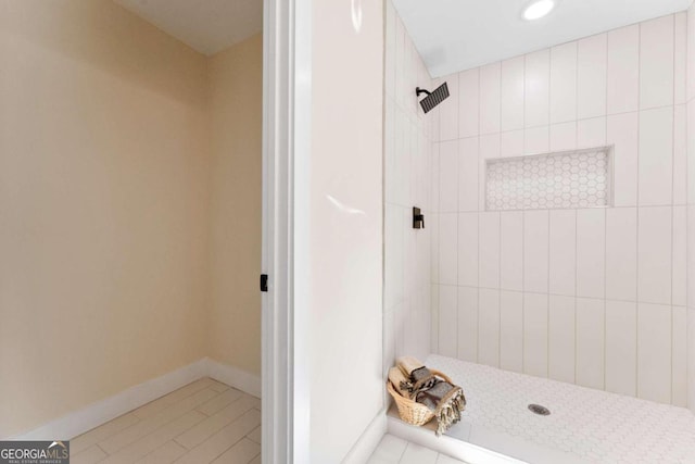 bathroom with tile patterned floors and a tile shower