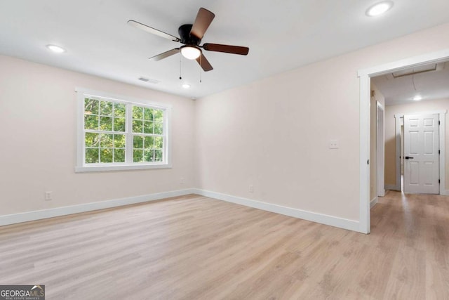 spare room featuring ceiling fan and light hardwood / wood-style floors