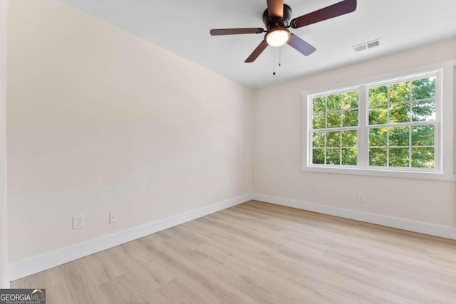 spare room with ceiling fan and light wood-type flooring