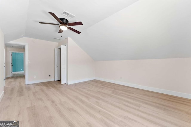 bonus room with light wood-type flooring, vaulted ceiling, and ceiling fan