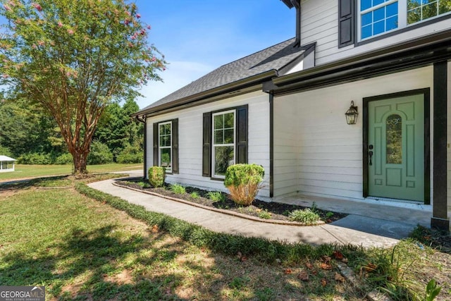 property entrance with a lawn