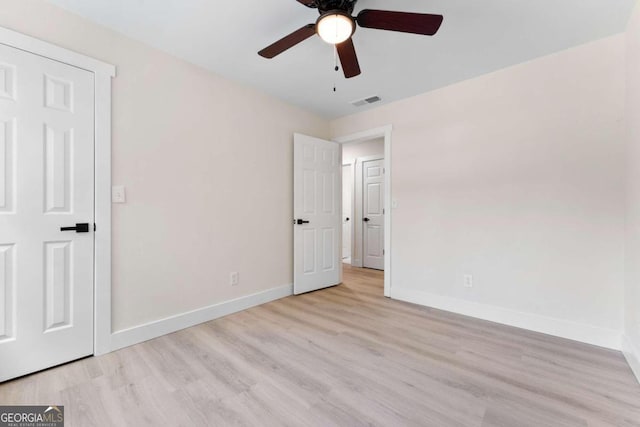 unfurnished bedroom with ceiling fan and light hardwood / wood-style floors