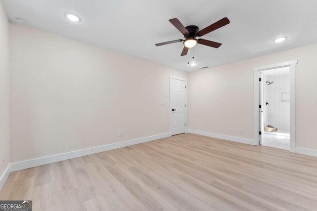 empty room featuring ceiling fan and light hardwood / wood-style floors