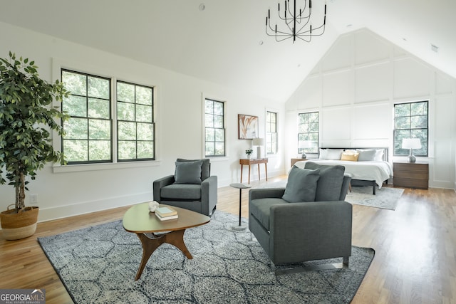 bedroom featuring hardwood / wood-style floors, a chandelier, and high vaulted ceiling