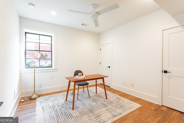 home office featuring light hardwood / wood-style floors and ceiling fan