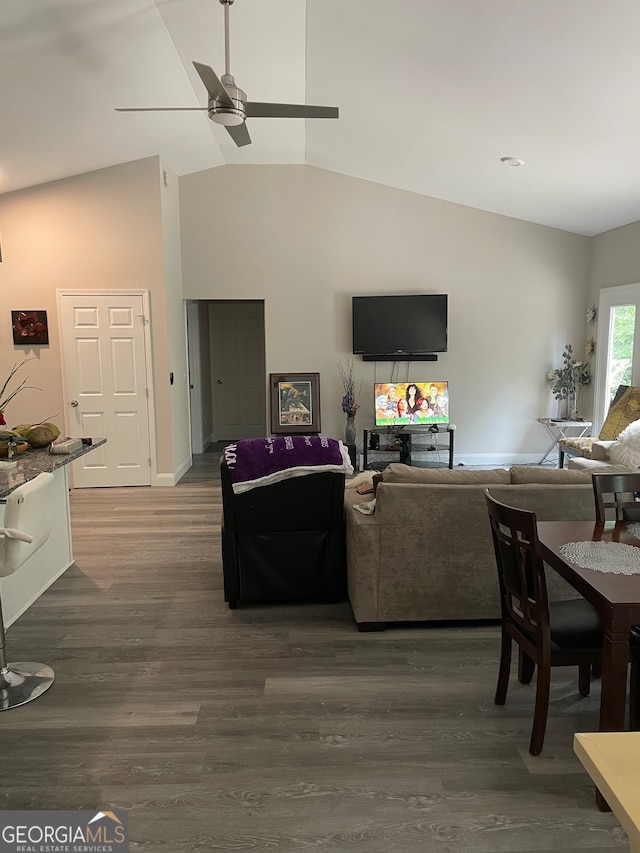 living room with vaulted ceiling, ceiling fan, and dark hardwood / wood-style flooring