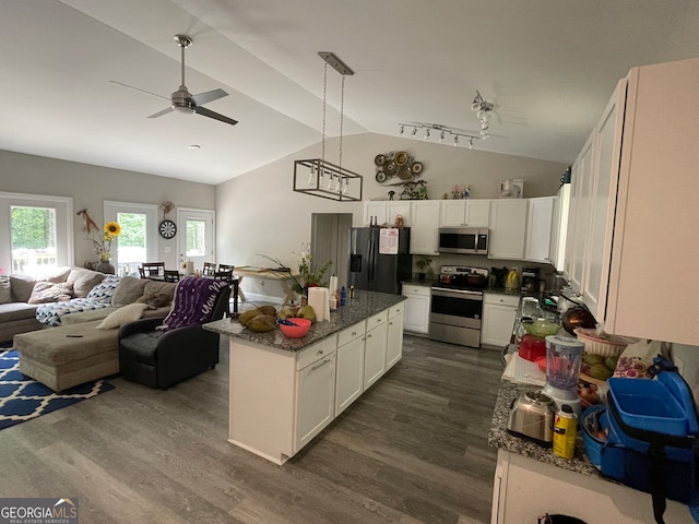 kitchen featuring vaulted ceiling, dark hardwood / wood-style floors, stainless steel appliances, white cabinetry, and ceiling fan