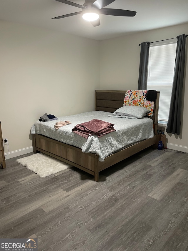 bedroom with ceiling fan and dark hardwood / wood-style floors