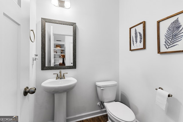 321 Brown Station Dr, Williamson, GA 30292 - half bathroom featuring toilet, wood finished floors, a sink, and baseboards