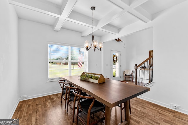 dining space featuring hardwood / wood-style floors, a chandelier, coffered ceiling, and beam ceiling